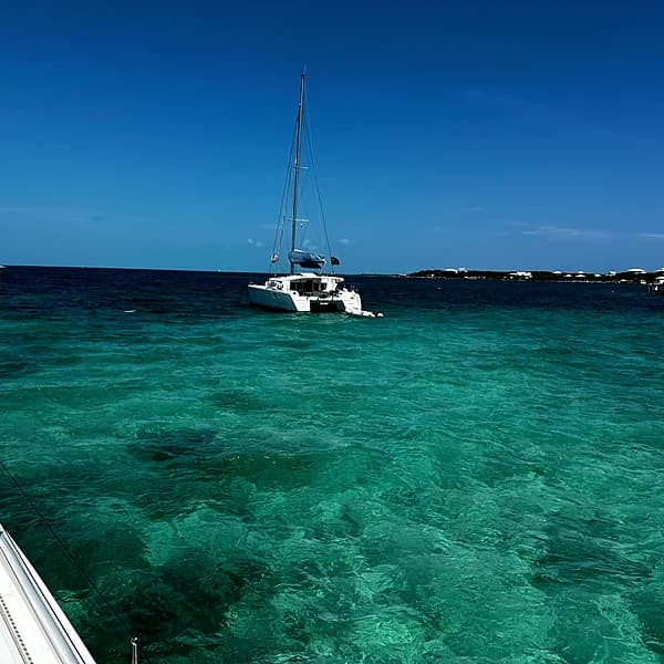A catamaran at anchor in Great Guana Cay's Settlement Harbour, near Nipper's