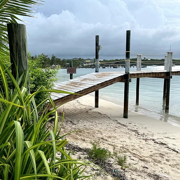 The dock at Little Harbour with a stormy Sea of Abaco sky behind