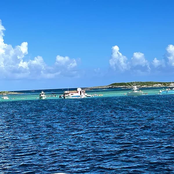 Boats and swimmers around the Thirsty Cuda floating bar at the Tahiti Beach sandbar, south end of Elbow Cay