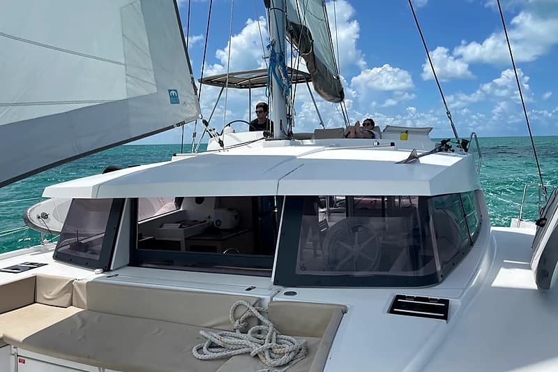 Underway at the helm, blue water and a fair wind across the Exuma Sound