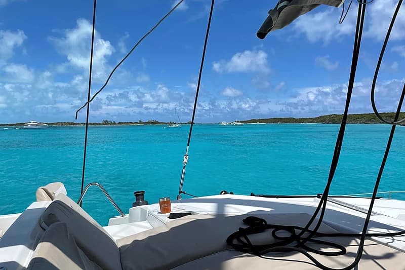 Sundowner at anchor in the Exumas — golden light on calm water